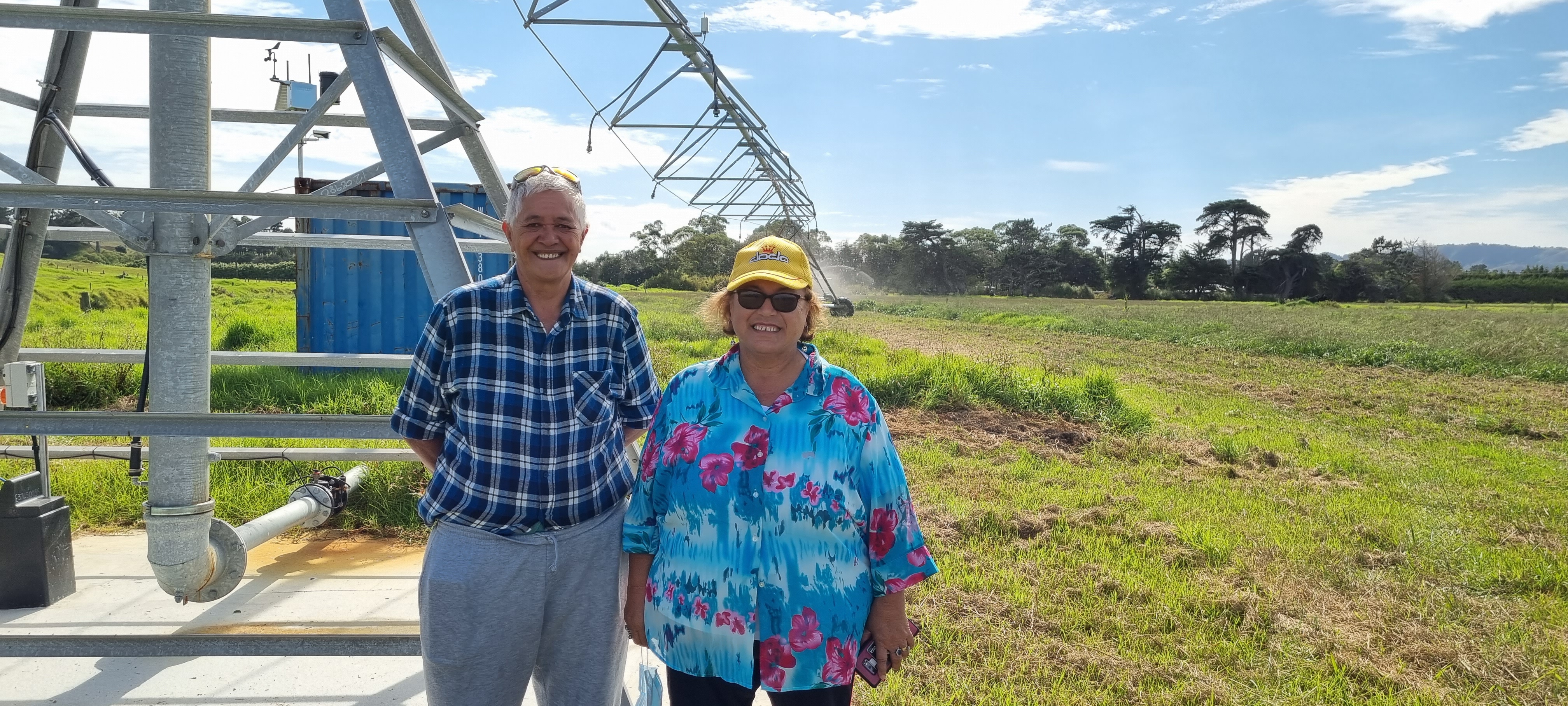Grace le Gros of Māuri Orā ki Ngāti Whatua Charitable Trust services stand with her colleague on Site 2. The centre pivot irrigator supplying the water to the site is shown in the background.